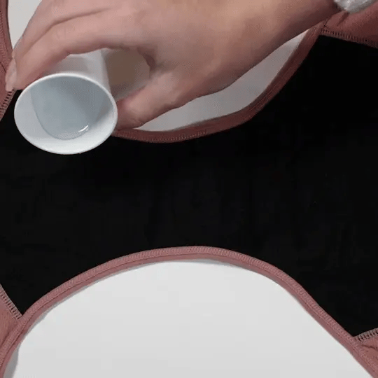 Rose-Anne absorption demo — liquid poured onto the gusset